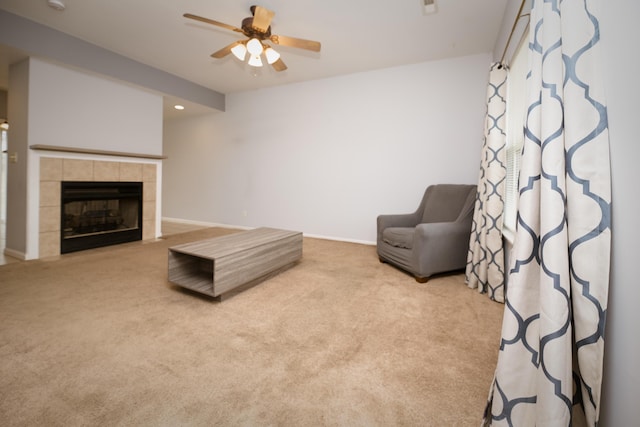 living area with a ceiling fan, recessed lighting, carpet, baseboards, and a tile fireplace