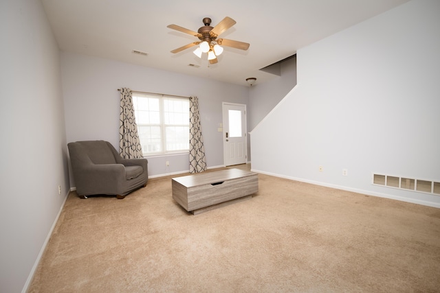 living area featuring visible vents, carpet floors, and ceiling fan