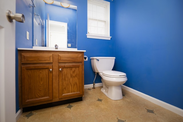 bathroom featuring vanity, visible vents, baseboards, tile patterned flooring, and toilet