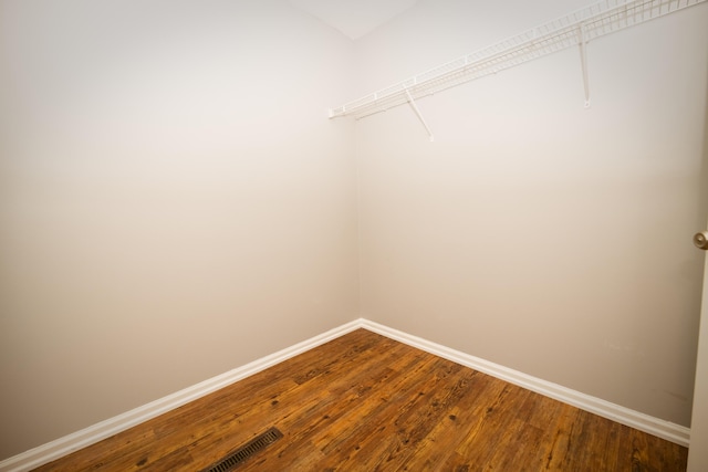 walk in closet featuring dark wood-style floors and visible vents