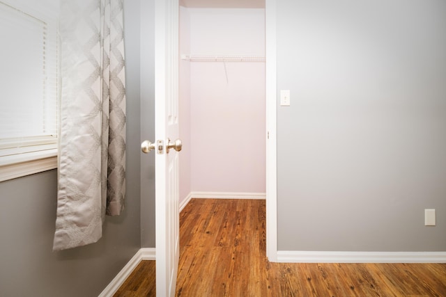 interior space with wood finished floors and baseboards