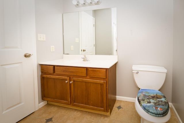 bathroom with tile patterned floors, toilet, vanity, and baseboards