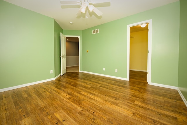 unfurnished bedroom with visible vents, baseboards, and wood finished floors