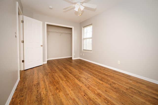 unfurnished bedroom with a closet, ceiling fan, baseboards, and wood finished floors