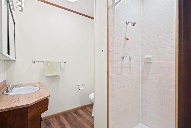 bathroom featuring vanity, toilet, wood finished floors, and a shower stall