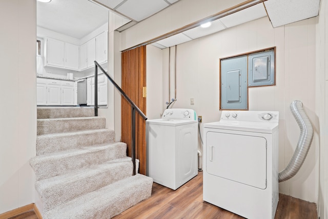 washroom with washer and dryer, light wood-style floors, laundry area, and electric panel