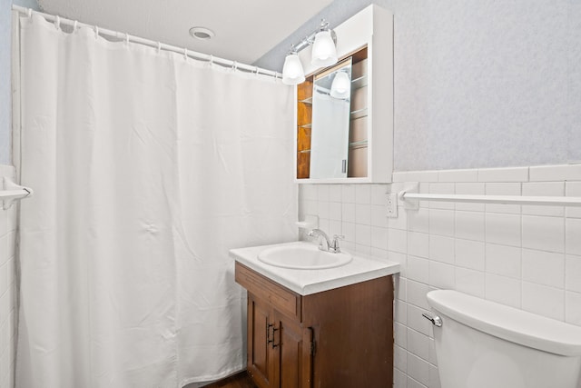 full bath featuring vanity, toilet, tile walls, and a shower with curtain