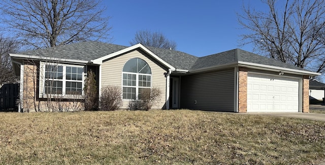 ranch-style house featuring brick siding, a shingled roof, a front lawn, driveway, and an attached garage