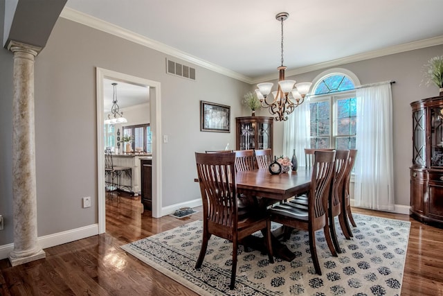 dining area featuring wood finished floors, visible vents, baseboards, an inviting chandelier, and ornamental molding