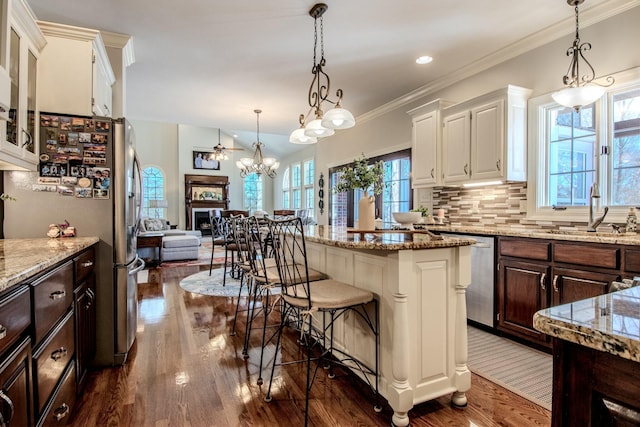 kitchen with a sink, tasteful backsplash, dark wood-style floors, appliances with stainless steel finishes, and white cabinets