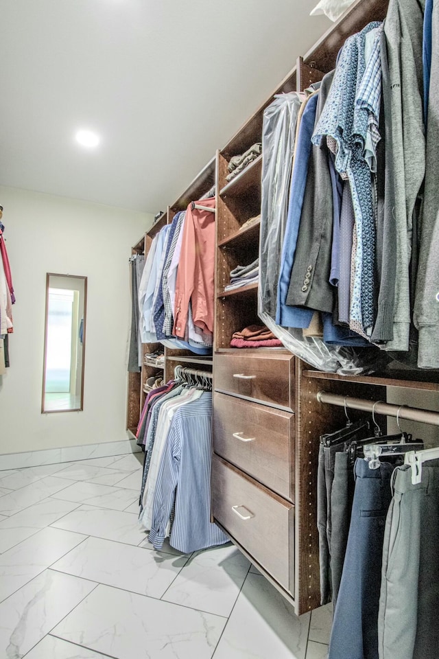 spacious closet with marble finish floor