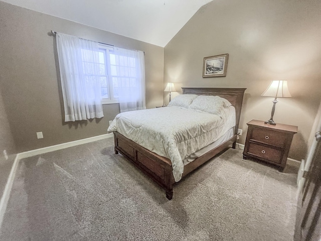 bedroom featuring baseboards, lofted ceiling, and carpet floors