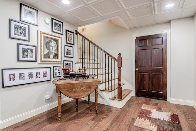 foyer featuring stairs, recessed lighting, wood finished floors, and baseboards