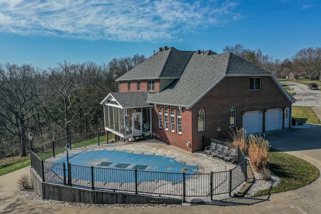 view of pool featuring a fenced in pool, a patio, fence, and a sunroom