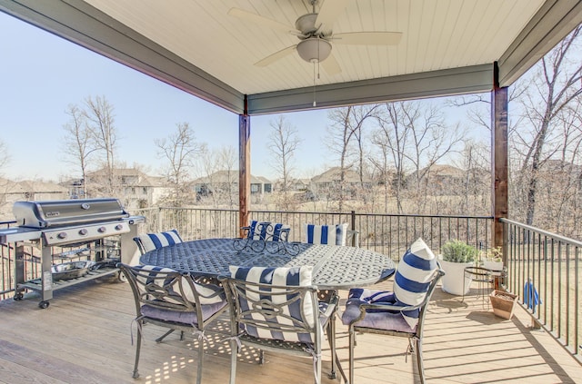 deck featuring grilling area, outdoor dining space, and ceiling fan