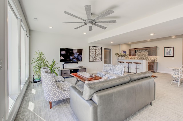 living area featuring recessed lighting, baseboards, and ceiling fan