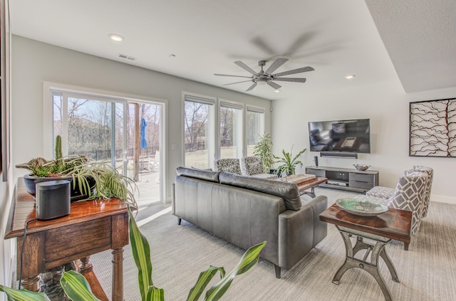 living area featuring light carpet, visible vents, recessed lighting, and a ceiling fan