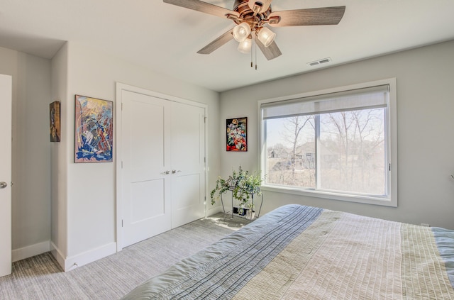 unfurnished bedroom with visible vents, ceiling fan, baseboards, carpet floors, and a closet