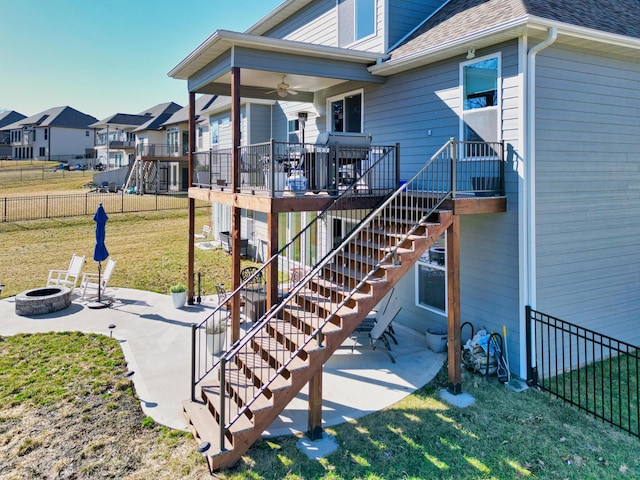 back of house with a patio, stairway, fence, an outdoor fire pit, and a lawn