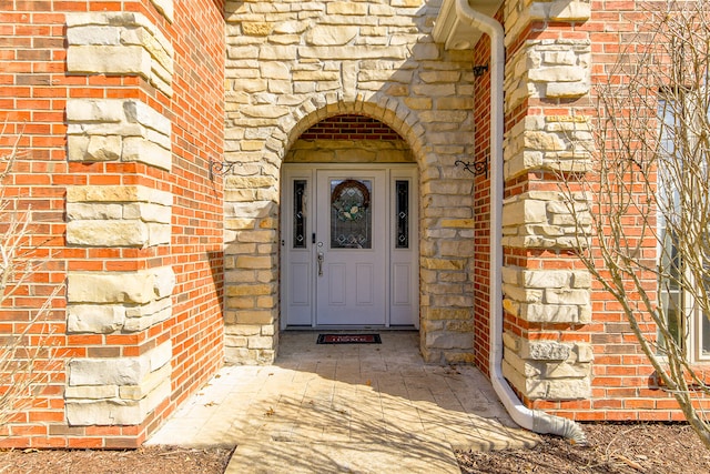 property entrance with brick siding and stone siding