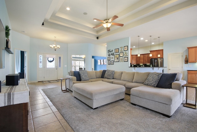 living area with light tile patterned floors, a raised ceiling, a towering ceiling, and recessed lighting