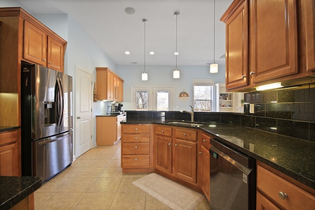 kitchen with tasteful backsplash, light tile patterned floors, dishwashing machine, stainless steel fridge, and a sink