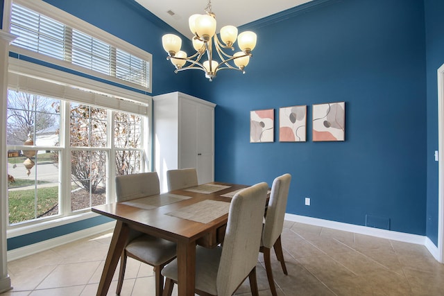 dining room featuring light tile patterned floors, baseboards, and an inviting chandelier