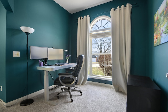 carpeted office space featuring baseboards and a healthy amount of sunlight