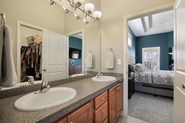 full bath featuring double vanity, ensuite bath, and a sink