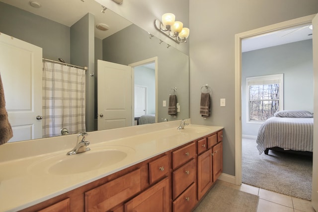 full bath featuring a sink, ensuite bath, double vanity, and tile patterned flooring