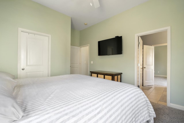 tiled bedroom featuring baseboards, carpet floors, and ceiling fan