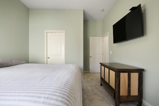 bedroom with light carpet and baseboards