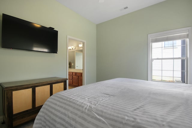 bedroom featuring visible vents and ensuite bathroom