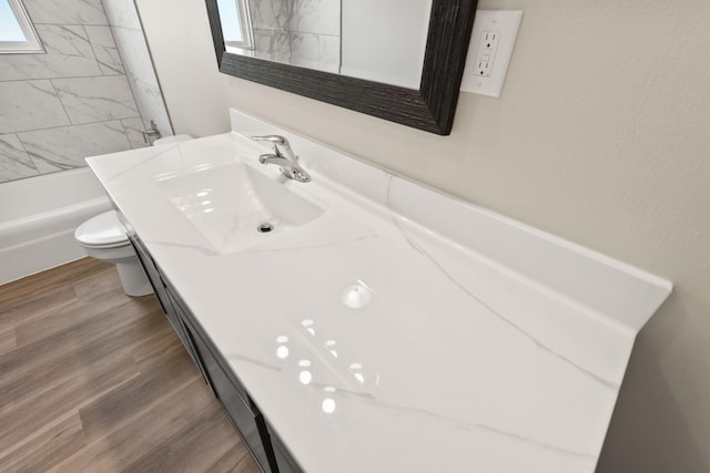 full bath featuring vanity, toilet, and wood finished floors