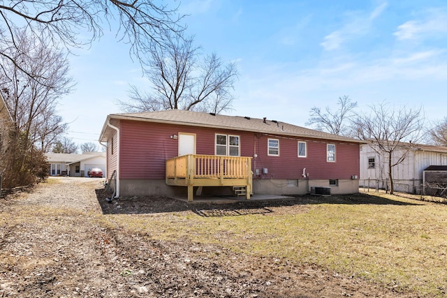 rear view of house with central air condition unit, a yard, and a deck