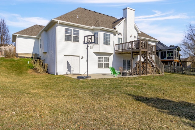 rear view of house with fence, a wooden deck, stairs, a yard, and a patio