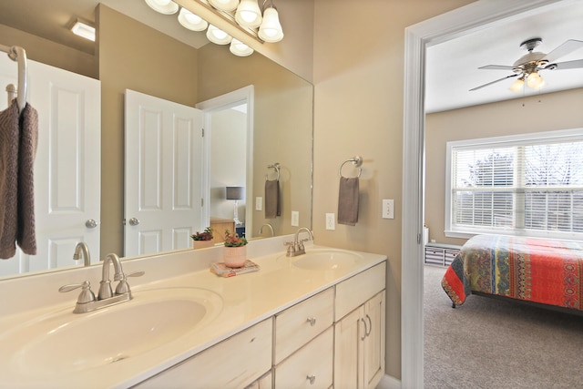 bathroom with ceiling fan, double vanity, ensuite bathroom, and a sink