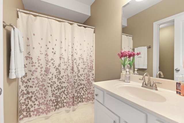 bathroom with curtained shower and vanity