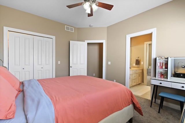 bedroom with visible vents, ceiling fan, a sink, a closet, and light colored carpet