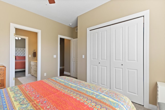 bedroom with a closet, ceiling fan, and ensuite bathroom