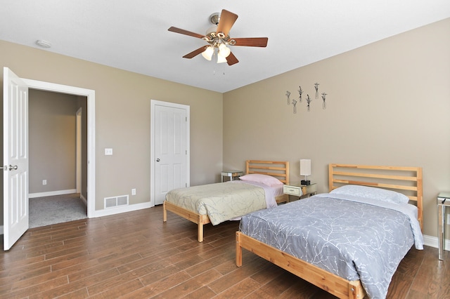 bedroom featuring visible vents, baseboards, wood finished floors, and a ceiling fan