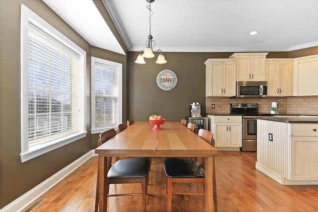 kitchen featuring tasteful backsplash, dark countertops, stainless steel appliances, light wood-style floors, and baseboards