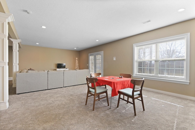 carpeted dining space featuring recessed lighting, visible vents, baseboards, and a textured ceiling