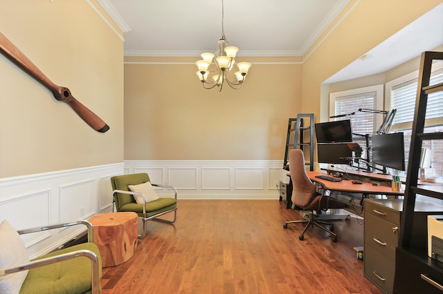 home office featuring wainscoting, ornamental molding, an inviting chandelier, and wood finished floors