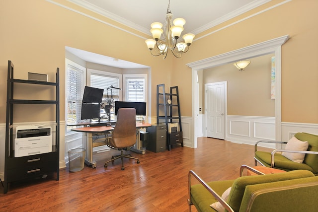 office featuring crown molding, a notable chandelier, wood finished floors, and a wainscoted wall