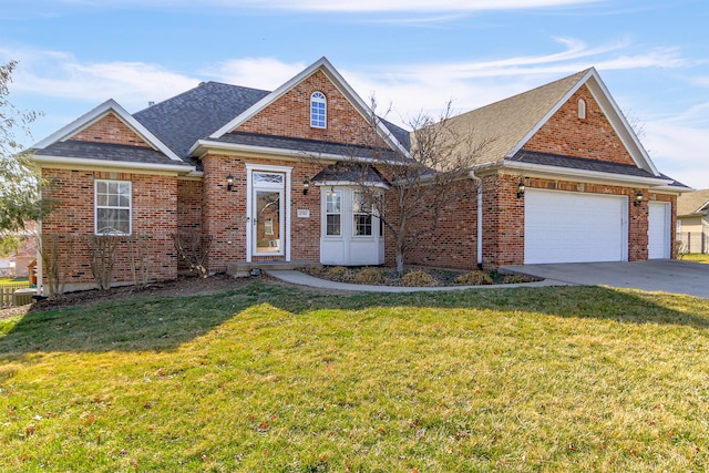 view of front of home featuring brick siding, an attached garage, a front yard, roof with shingles, and driveway