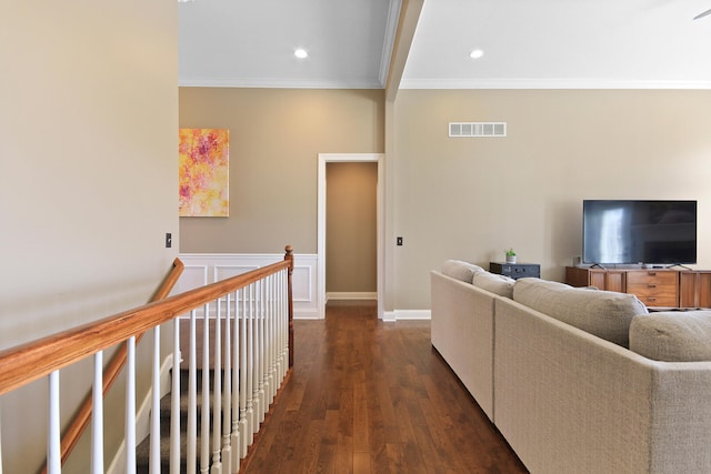 living area featuring dark wood-type flooring, recessed lighting, visible vents, and ornamental molding