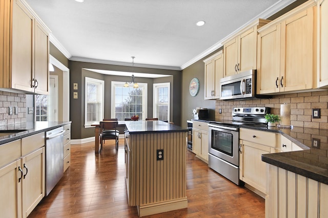 kitchen featuring stainless steel appliances, dark countertops, and dark wood-style flooring