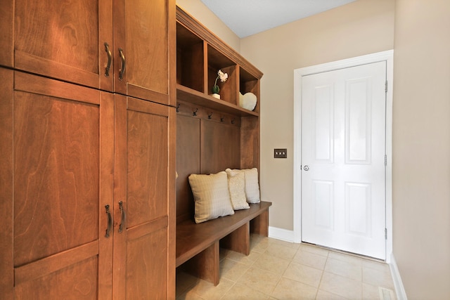 mudroom with baseboards and light tile patterned flooring