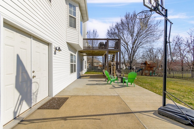 view of patio / terrace featuring a playground, stairs, and fence